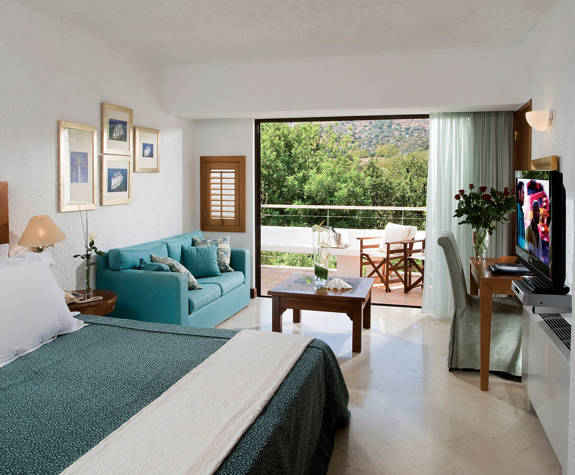 Elounda Bay Palace family room garden view big bed, couch and amenities