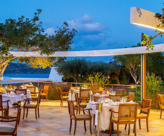 Elounda Bay Palace Aretoussa Restaurant exterior sitting area at night and decorations