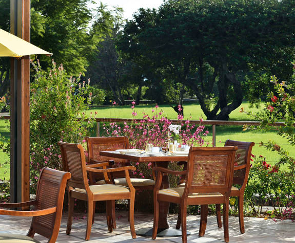 Elounda Bay Palace Aretoussa Restaurant exterior table next to the garden