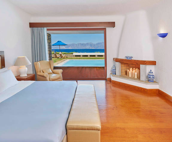 Elounda Bay Palace the palace suite bedroom with fireplace