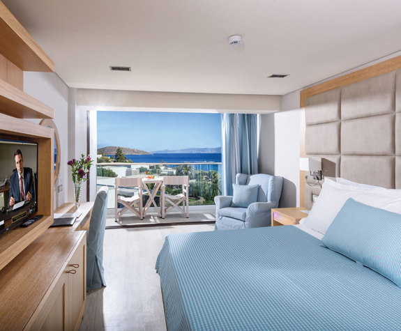 Elounda Bay Palace room with double bed, armchair and amenities