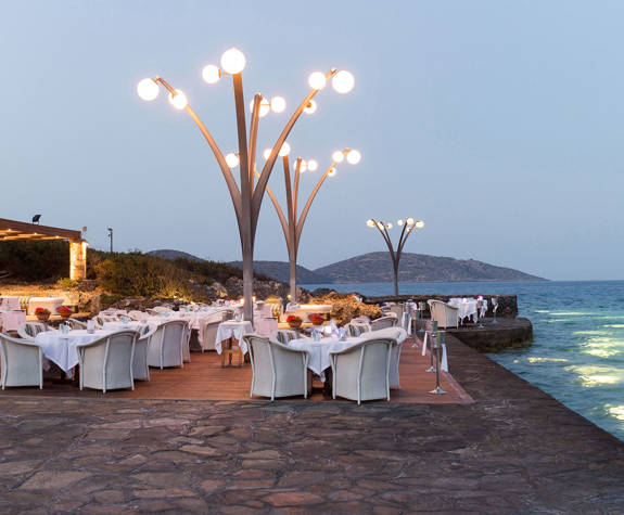 Elounda Bay Palace Thalassa Restaurant tables and decorations at the dock at night