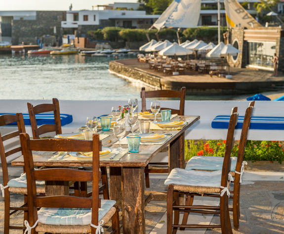 Elounda Bay Palace Ariadne Restaurant table for six with the sea in the background