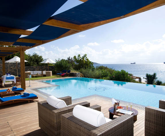 Elounda Bay Palace grand suite sunbeds and armchairs in front of the private pool