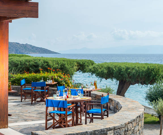 Elounda Bay Palace Ariadne Restaurant tables with clear view of the sea