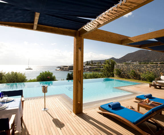 Elounda Bay Palace grand suite sunbeds and table in front of the private pool